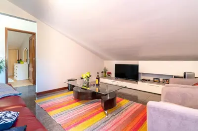 a living room with a couch and a table at Casa Por Do Sol in Ponta do Sol