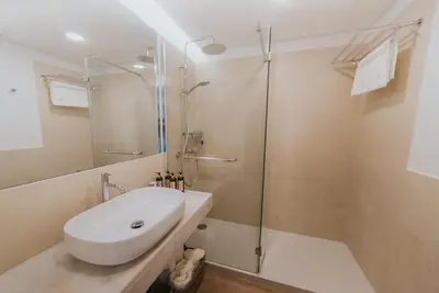 a bathroom with a sink and a glass shower at Studio Marina by Madeira Best Apartments in Funchal