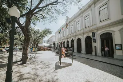 a picture of a woman on a sidewalk in front of a building at Studio Marina by Madeira Best Apartments in Funchal