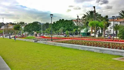 a park with colorful flowers and trees and buildings at Studio Marina by Madeira Best Apartments in Funchal
