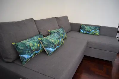 a brown couch with three pillows on it at Apart. Madeira 4 you in Funchal