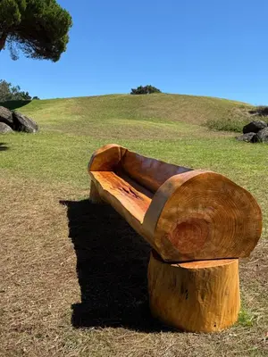a wooden bench sitting on top of a field at Apart. Madeira 4 you in Funchal