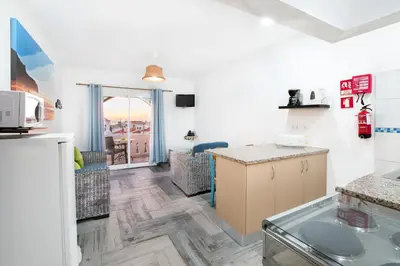 a kitchen and living room with a counter top at Tonel Apartamentos Turisticos in Sagres