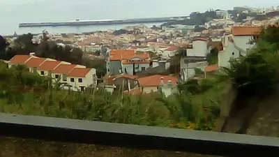 a view of a city with houses and the ocean at House Joel & Sónia in Funchal
