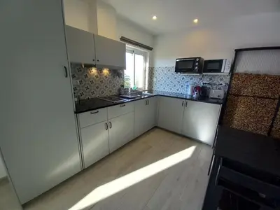 a kitchen with white cabinets and a window at Martins Apartment - Belch1952 in Lagos