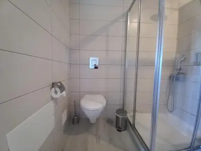 a bathroom with a toilet and a shower at Martins Apartment - Belch1952 in Lagos
