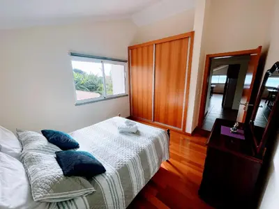 a bedroom with a bed with blue pillows on it at Casa Simão in Calheta