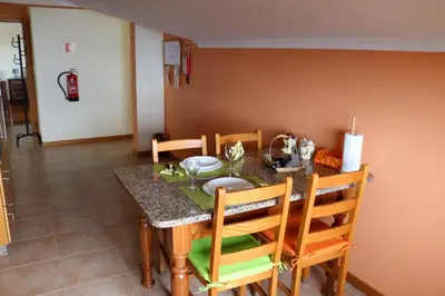 a dining room table and chairs with a table and chairsktop at Casa Simão in Calheta
