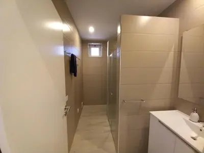 a bathroom with a shower and a sink at Belchior Apartment - Belch1952 in Lagos