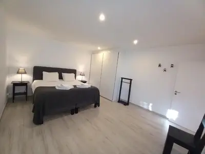 a bedroom with a bed and a table and a mirror at Belchior Apartment - Belch1952 in Lagos