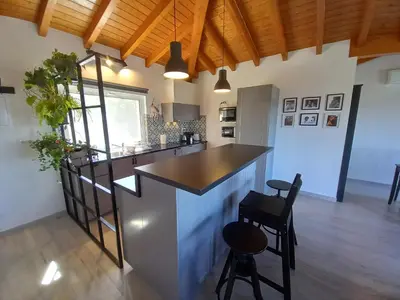 a kitchen with a counter and a bar with stools at Carlos Apartment - Penthouse - Belch1952 in Lagos