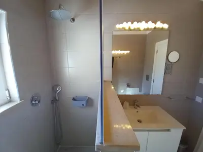 a bathroom with a shower and a sink and a mirror at Carlos Apartment - Penthouse - Belch1952 in Lagos