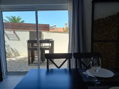a table and chairs with a view of a patio at Lopes Apartment - Belch1952 in Lagos