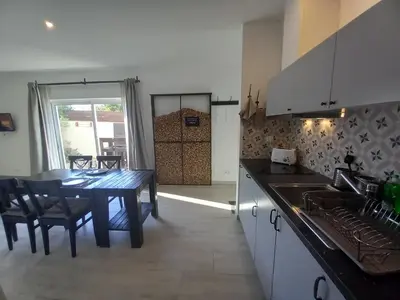 a kitchen with a table and a dining room at Lopes Apartment - Belch1952 in Lagos