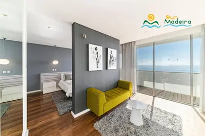 a living room with a yellow couch and a bedroom at OurMadeira - Fonte do Mar 1 in Caniço