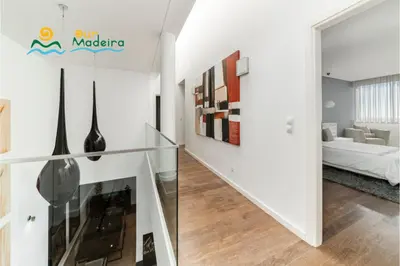 a hallway with a glass staircase in a house at OurMadeira - Fonte do Mar 1 in Caniço