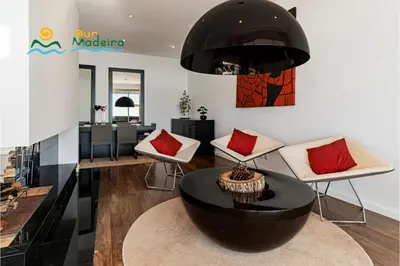 a living room with a table and chairs at OurMadeira - Fonte do Mar 1 in Caniço