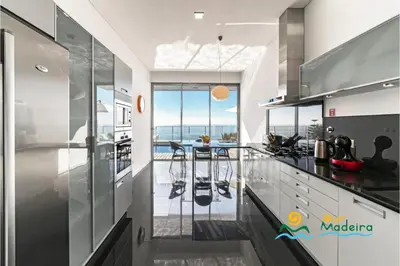 a kitchen with a view of the ocean at OurMadeira - Fonte do Mar 1 in Caniço