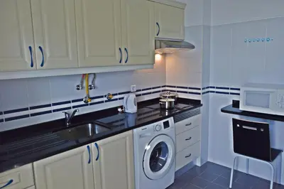 a kitchen with a sink and a washing machine at Apartment in Câmara de Lobos in Câmara de Lobos