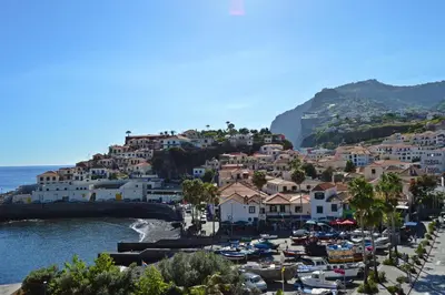 a view of a town with boats in the water at Apartment in Câmara de Lobos in Câmara de Lobos