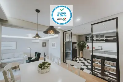 a kitchen and living room with a white table and chairs at Alto Lido by Madeira Best Apartments in Funchal