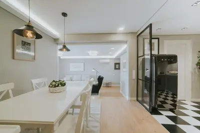 a kitchen and dining room with a white table and chairs at Alto Lido by Madeira Best Apartments in Funchal