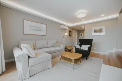 a living room with a couch and a chair at Alto Lido by Madeira Best Apartments in Funchal