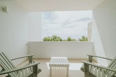 a white room with two benches and a window at Alto Lido by Madeira Best Apartments in Funchal