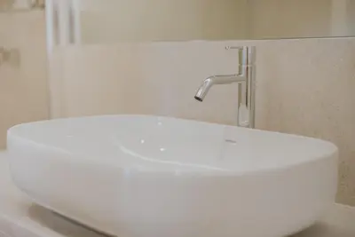 a white sink with a faucet in a bathroom at Alto Lido by Madeira Best Apartments in Funchal