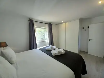 a bedroom with a bed with two towels on it at Manuel Apartment - Belch1952 in Lagos