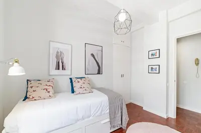 a bedroom with white walls and a bed with pillows at Quinta Deão I by An Island Apart in Funchal