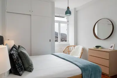 a bedroom with a bed with a mirror and a dresser at Quinta Deão I by An Island Apart in Funchal