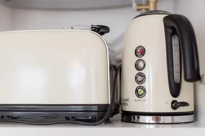 two toasters sitting next to each other on a counter at Apartamentos Praça Amarela by Heart of Funchal in Funchal