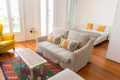 a living room with a couch and a bed at Apartamentos Praça Amarela by Heart of Funchal in Funchal