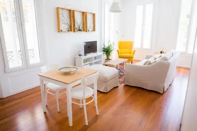 a living room with a table and a couch at Apartamentos Praça Amarela by Heart of Funchal in Funchal