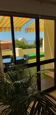 a view of a patio with a couch and a table at Apartamento Maria in Lagos