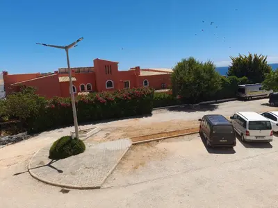 a parking lot with cars parked in front of a building at Apartamento Maria in Lagos