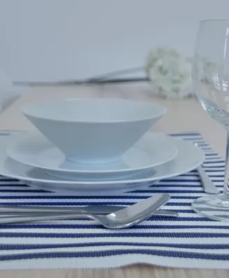 a white plate on a table with a fork and knife at Ribeira Funchal Center in Funchal
