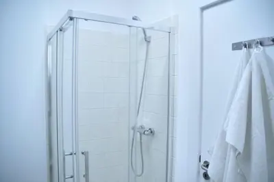 a shower with a glass door in a bathroom at Ribeira Funchal Center in Funchal