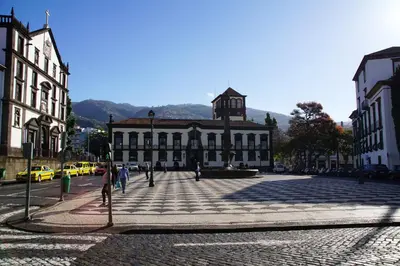 a building in a city with people walking in the street at Ribeira Funchal Center in Funchal