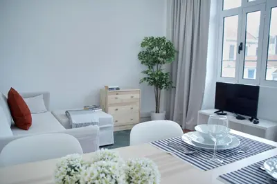 a white living room with a couch and a table at Ribeira Funchal Center in Funchal