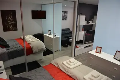 a room with two beds and a mirror at Sea and Sun 4 You - Choupana Studio in Funchal
