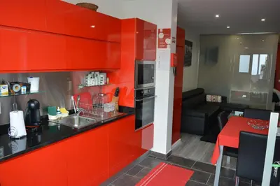 a kitchen with red cabinets and a red counter top at Sea and Sun 4 You - Choupana Studio in Funchal