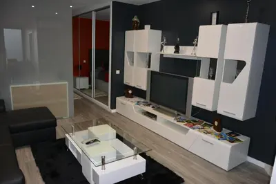 a living room with white furniture and a flat screen tv at Sea and Sun 4 You - Choupana Studio in Funchal