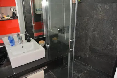 a bathroom with a sink and a shower at Sea and Sun 4 You - Choupana Studio in Funchal