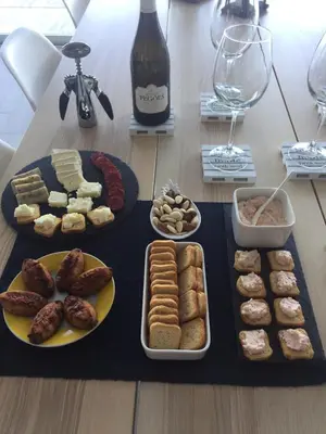a table with plates of food and a bottle of wine at DuMar Beachouse in Salema