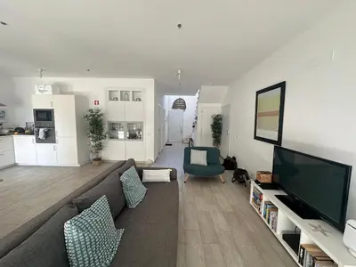 a living room with a couch and a flat screen tv at DuMar Beachouse in Salema