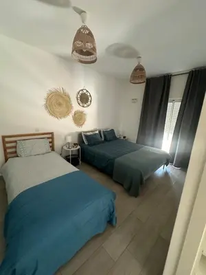 two beds in a bedroom with blue and white at DuMar Beachouse in Salema