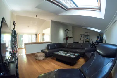 a living room with leather furniture and a skylight at PERFECT DUPLEX PISCINE Zone VIP Funchal in Funchal
