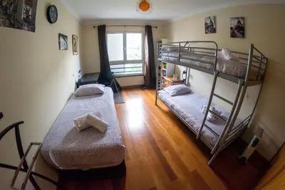 two bunk beds in a room with a cross on the floor at PERFECT DUPLEX PISCINE Zone VIP Funchal in Funchal